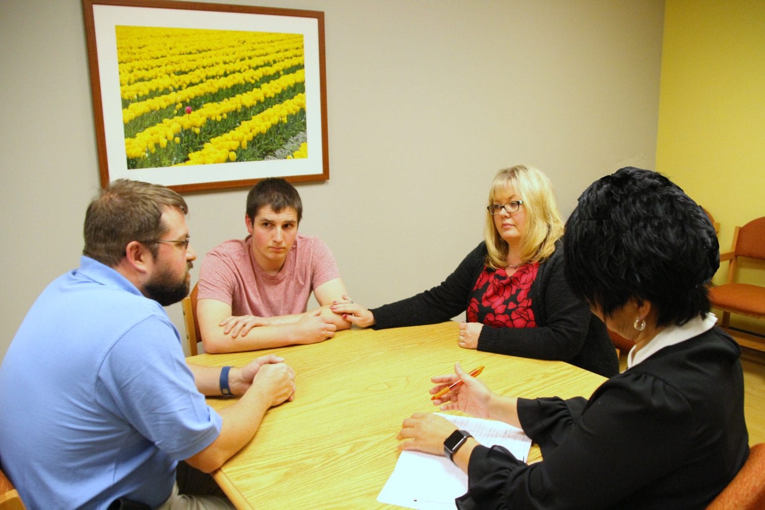 Parents with son receiving mental health assessment