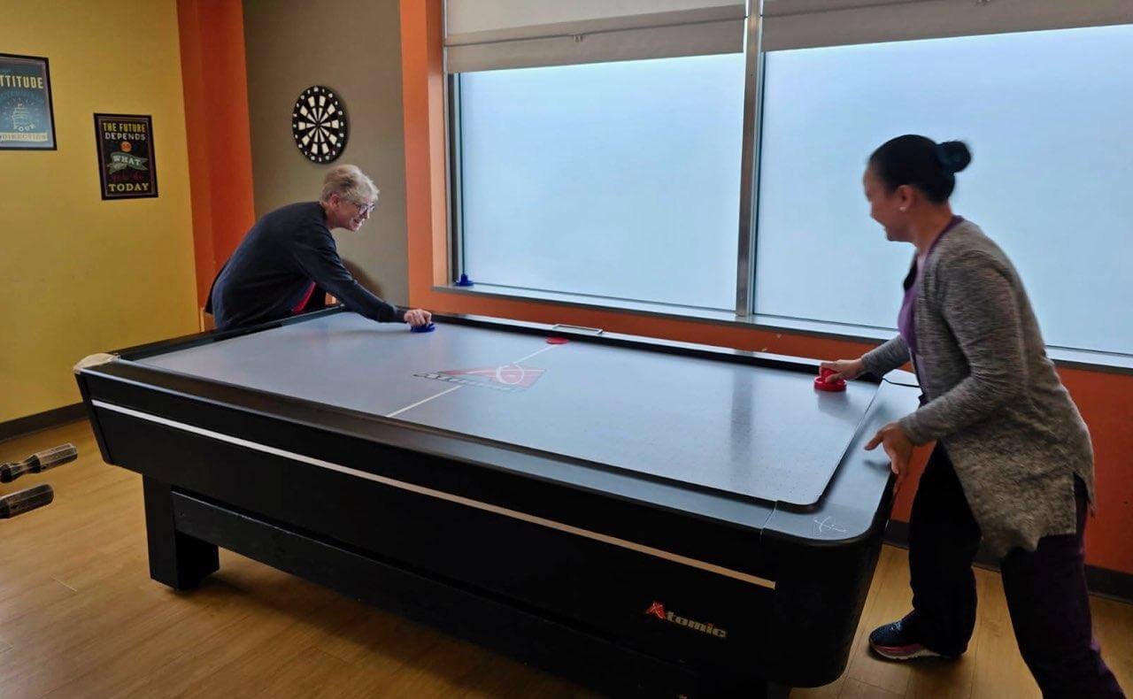 904051609-airhockey Adults playing air hockey